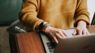 The Good Priming and Expectation-Setting article feature image of a person using a laptop to navigate a website.